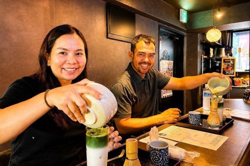 Two people preparing a drink with a shaker and a tall glass. 5
