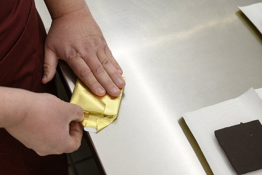 A person folding a piece of paper. 5