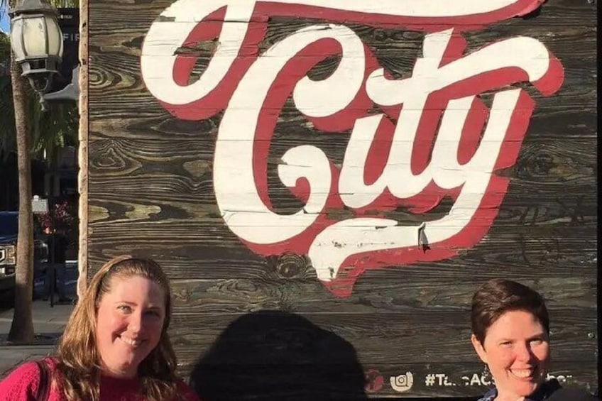 A wooden sign with the Coca-Cola logo. 5