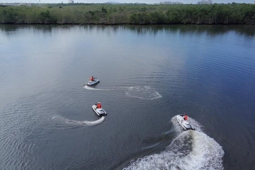 Three small boats on a calm body of water with a forested shoreline in the background. 2