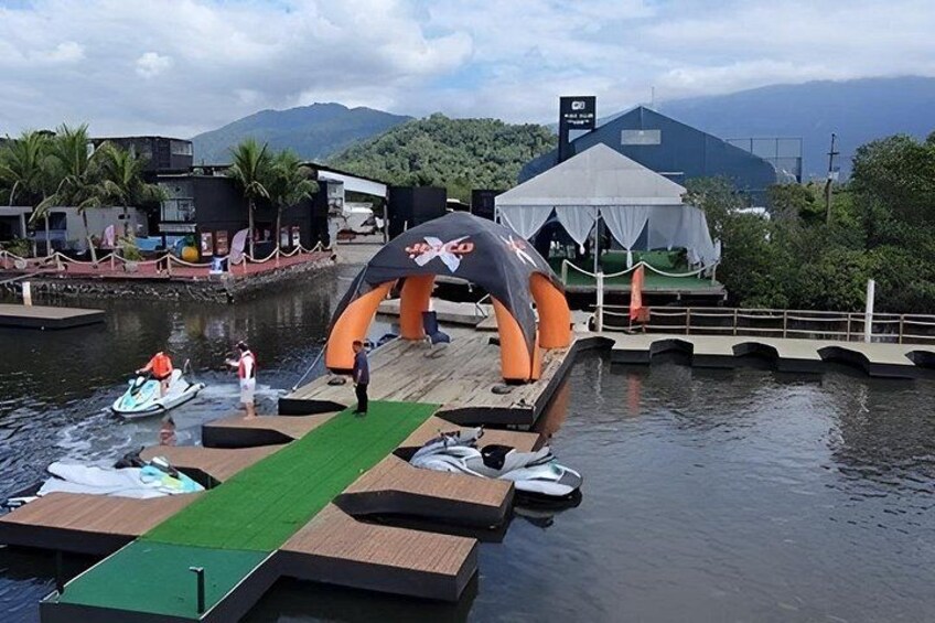 A waterway with a dock, boats, and a tent. 4
