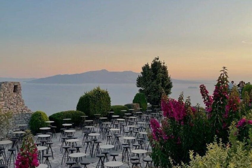 Outdoor seating with a view of the sea and mountains. 5