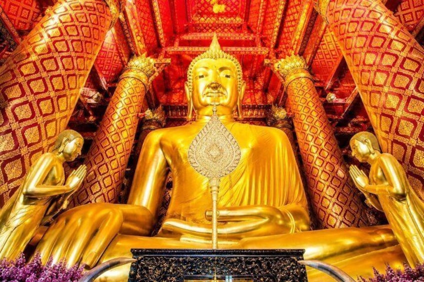 A golden Buddha statue surrounded by ornate architecture. 4