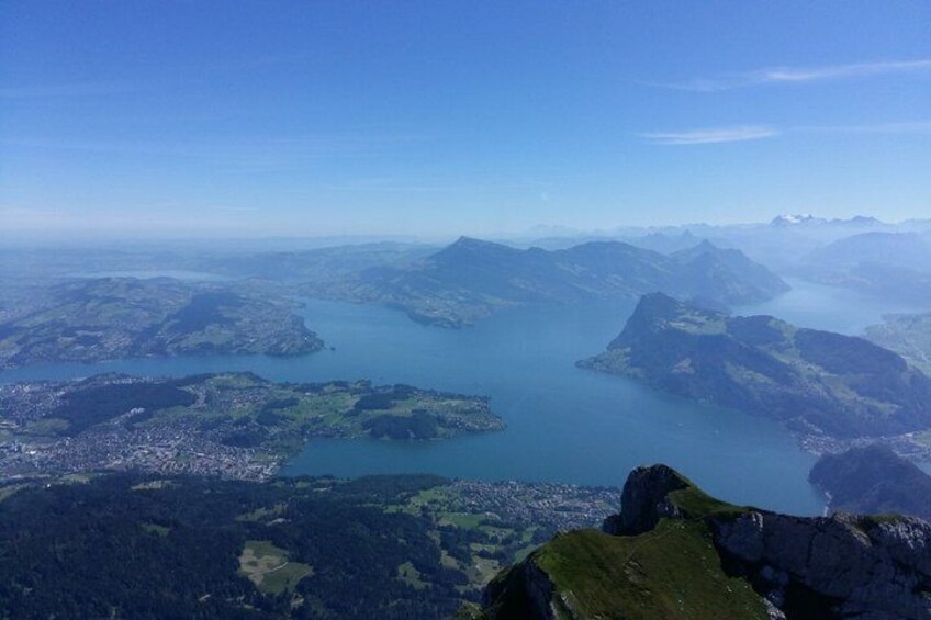 A mountainous landscape with a large lake and a town. 5