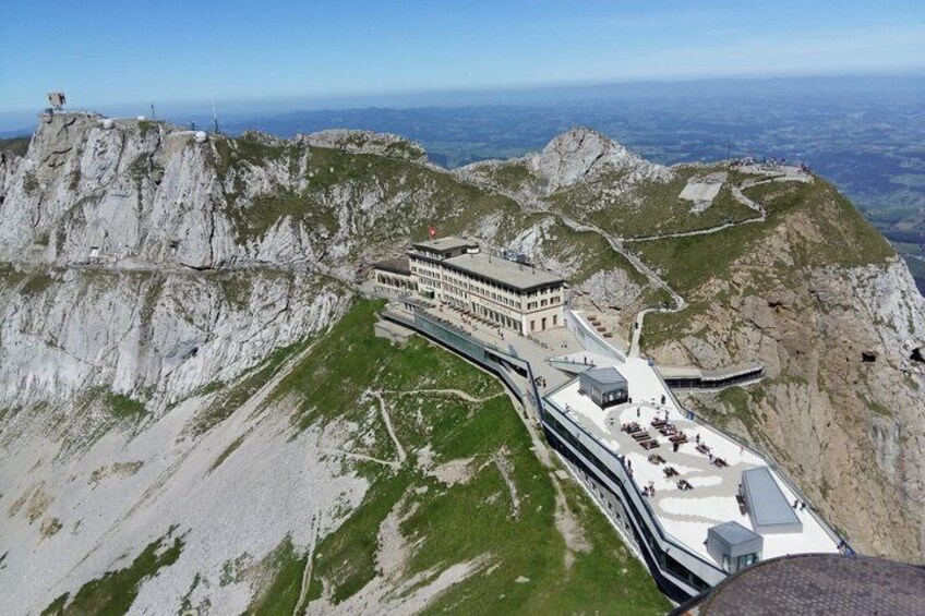 A mountain lodge with a winding road and steep cliffs. 1