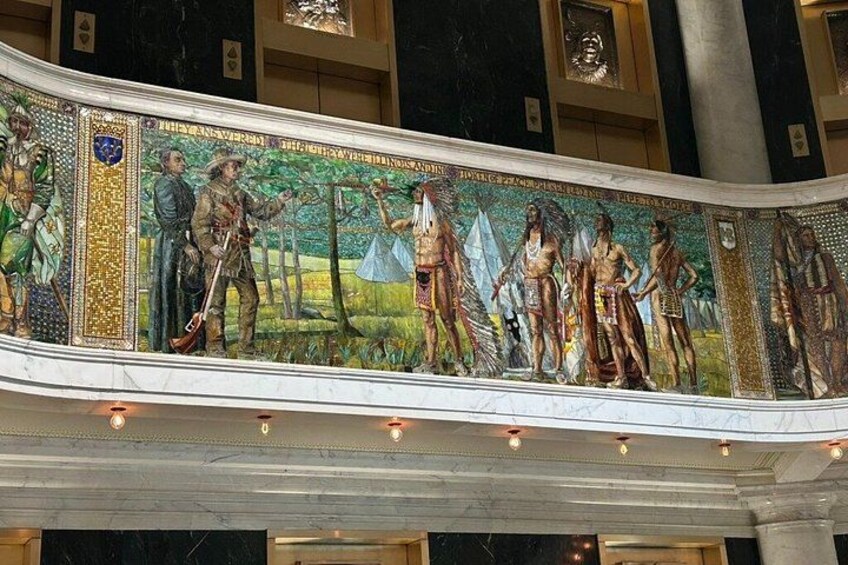 A mosaic with figures in historical attire, set against a marble background. 5