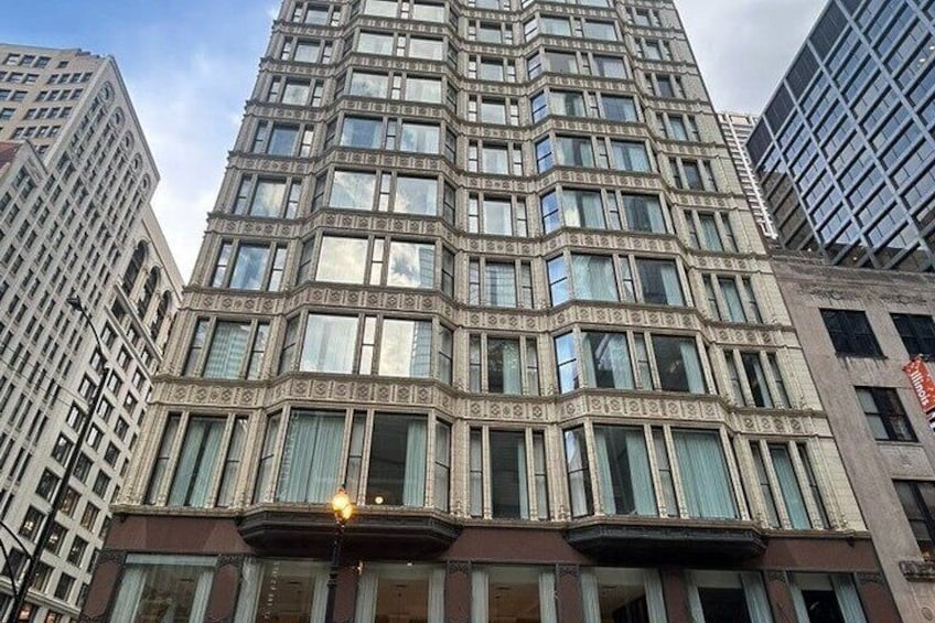A tall, ornate building with a patterned facade and large windows. 2