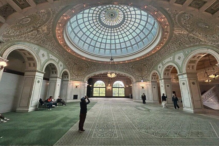A large hall with a high, ornate ceiling and a central dome. 2