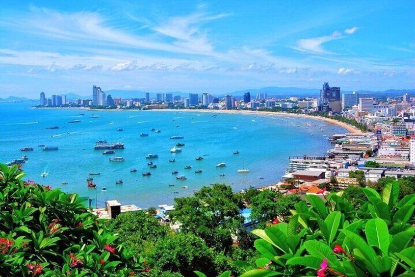 A coastal cityscape with a beach, boats, and dense urban buildings. 2