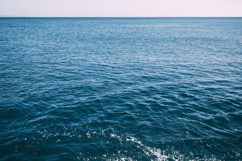 A calm sea with gentle waves and a clear horizon. 4