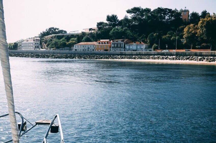 Calm water, a boat, a dock, and buildings along a shoreline. 3
