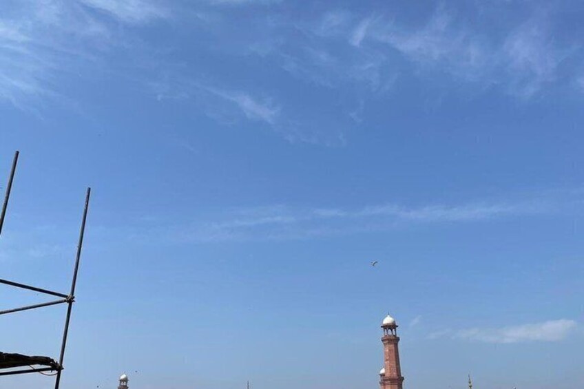 A clear sky with a tall tower and a smaller structure in the distance. 2
