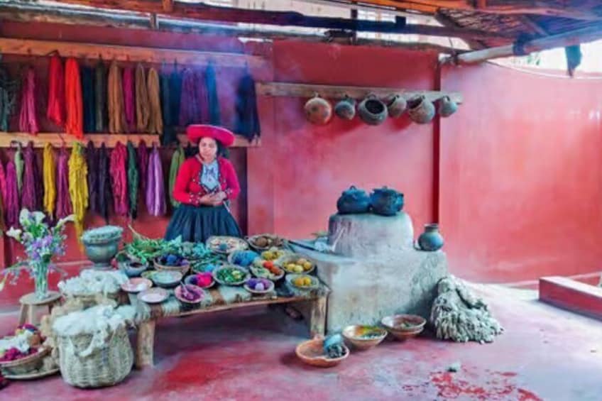 A market stall with colorful textiles, pottery, and a person in traditional attire. 5