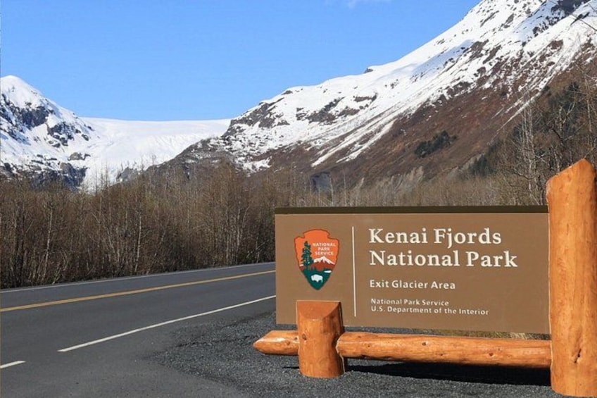 A road leading to Kenai Fjords National Park with a signboard. 3