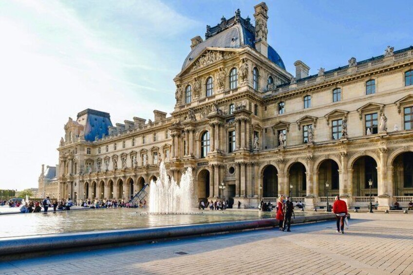 The Louvre Museum with a fountain in the courtyard. 5
