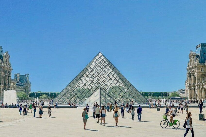 The Louvre Pyramid with visitors in the foreground. 1