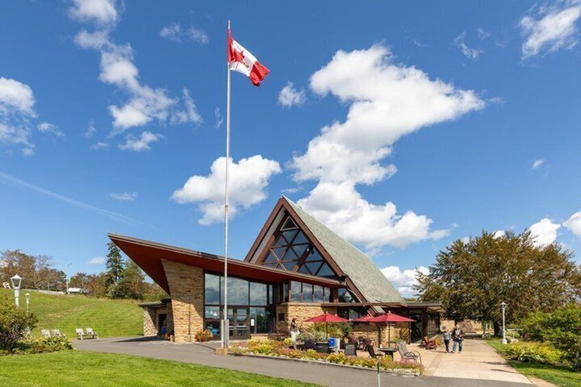 A building with a red roof, a Canadian flag, and a glass facade. 1