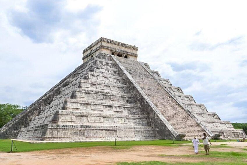 A large pyramid structure with a flat top and a steep staircase leading up to it. 1