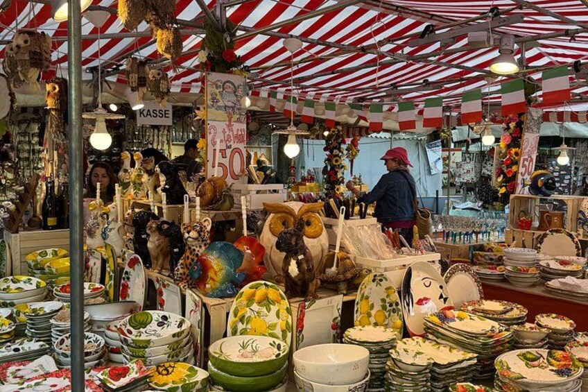 A market stall with various ceramic dishes and bowls. 2