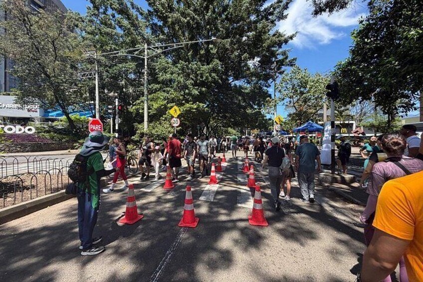 A busy street with pedestrians, traffic cones, and a McDonald's sign. 2