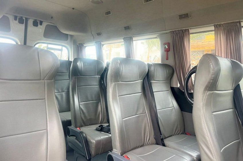A vehicle interior with leather seats and a steering wheel. 3