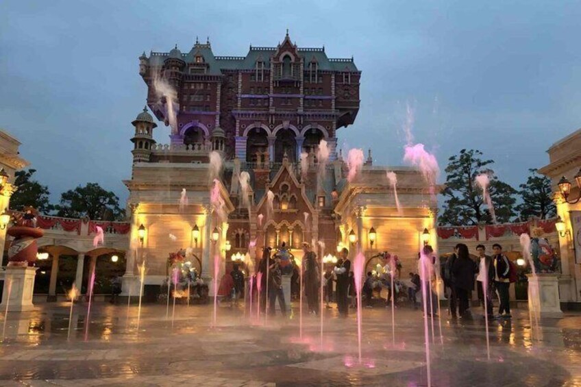 A castle-like building with a fountain in front. 4
