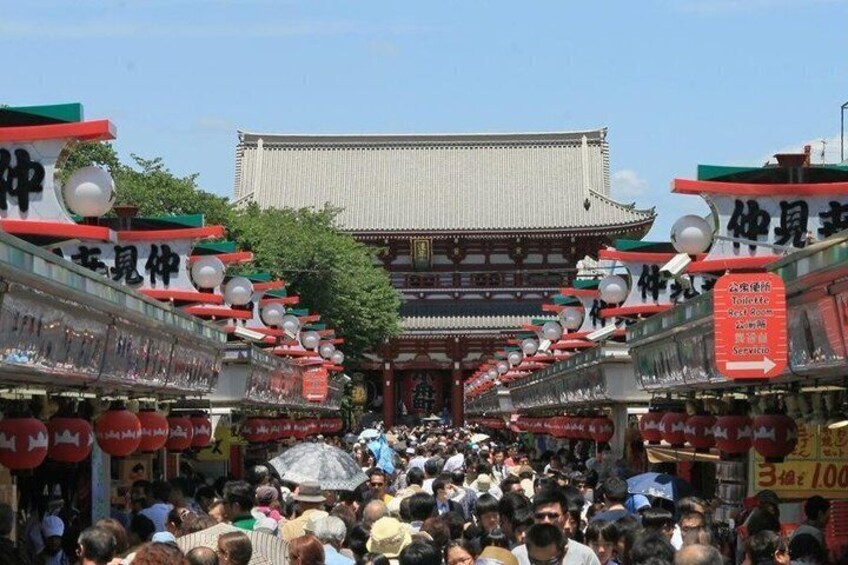 A traditional Japanese building with a crowd of people in front. 1
