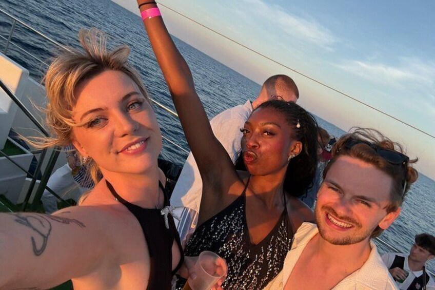A group of people on a boat with the ocean in the background. 3