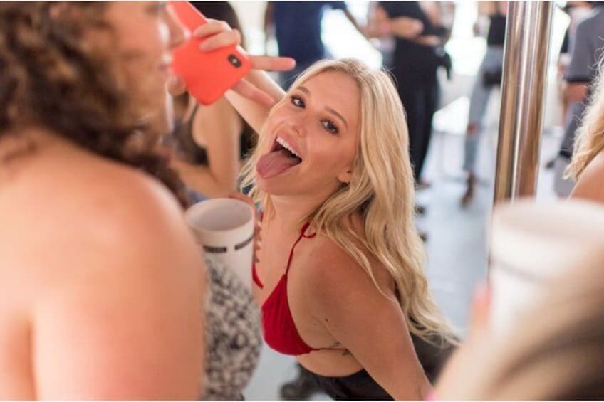 A person in a red swimsuit holding a phone. 1