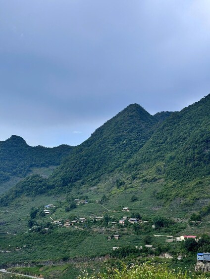 A mountainous landscape with terraced fields and scattered houses. 4