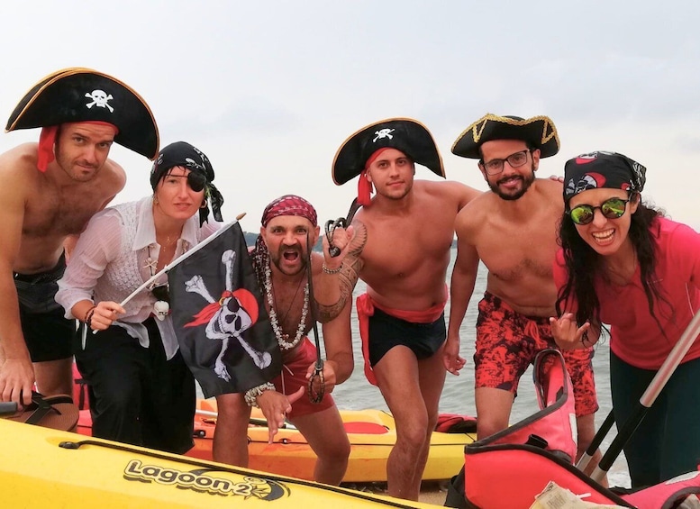 A group of people dressed as pirates on a boat. 1