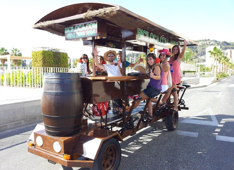 A wooden cart with a sign for BICILOCA.COM parked on a street. 1