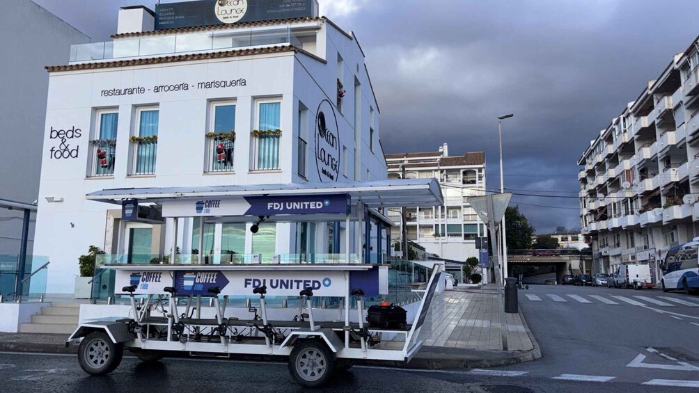 A white mobile coffee shop with 'FDJ UNITED' branding parked on a street. 2