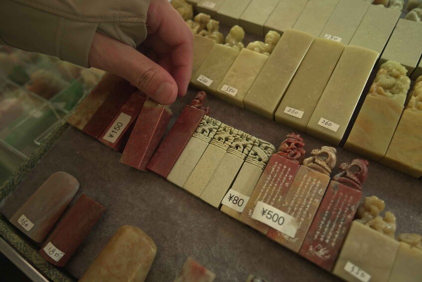 A variety of soap bars in a store, each with a price tag. 3