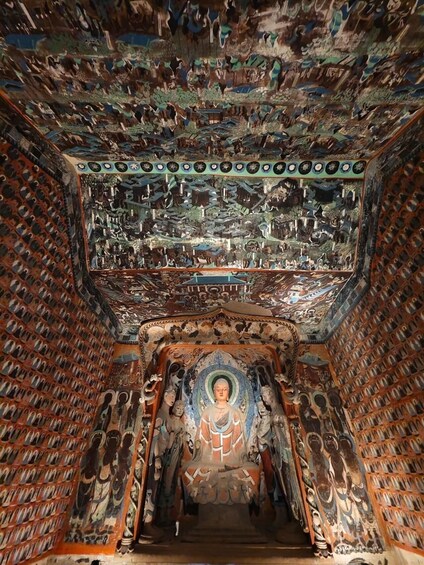 A temple interior with intricate murals and a central statue. 3