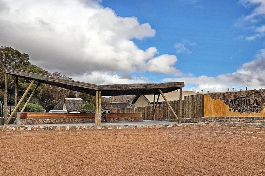 A wooden structure, possibly a pavilion, with a brick ground. 2
