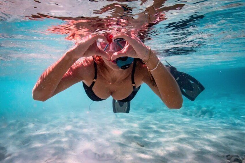 A person underwater, wearing a snorkel and fins. 3