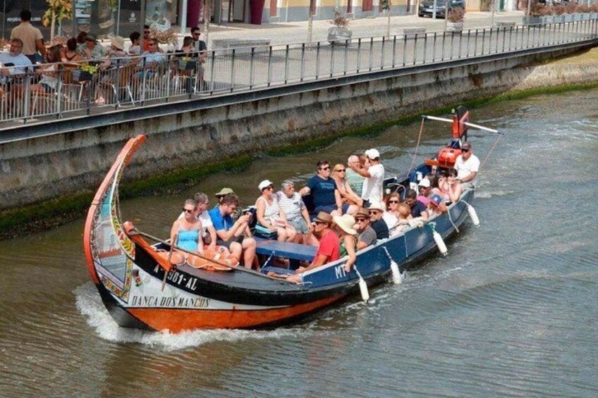 A boat with passengers, a bridge, and a waterfront. 3
