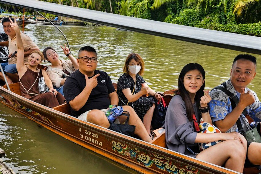 A group of people in a traditional boat on a river. 3