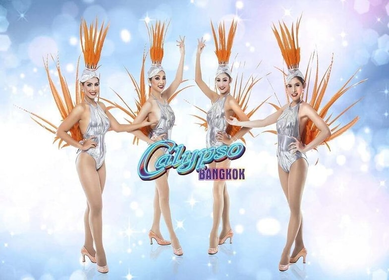 Four dancers in silver outfits with orange feathered headdresses, standing in a line with the text 'Calypso Bangkok' on the background. 3