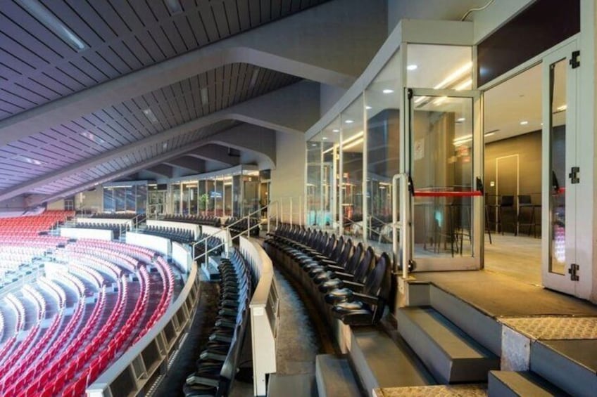 An indoor stadium with tiered seating, a glass entrance, and a modern architectural design. 5