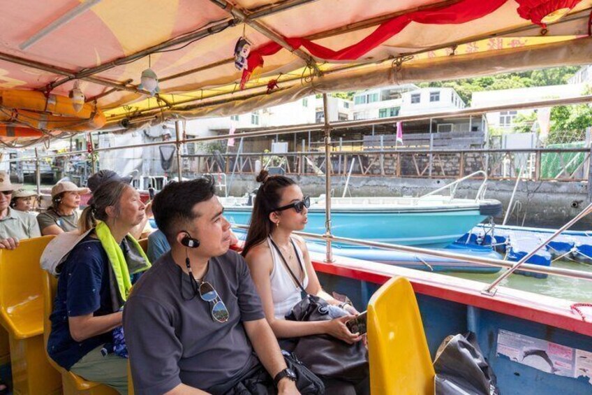 People on a boat with a view of a dock and water. 3