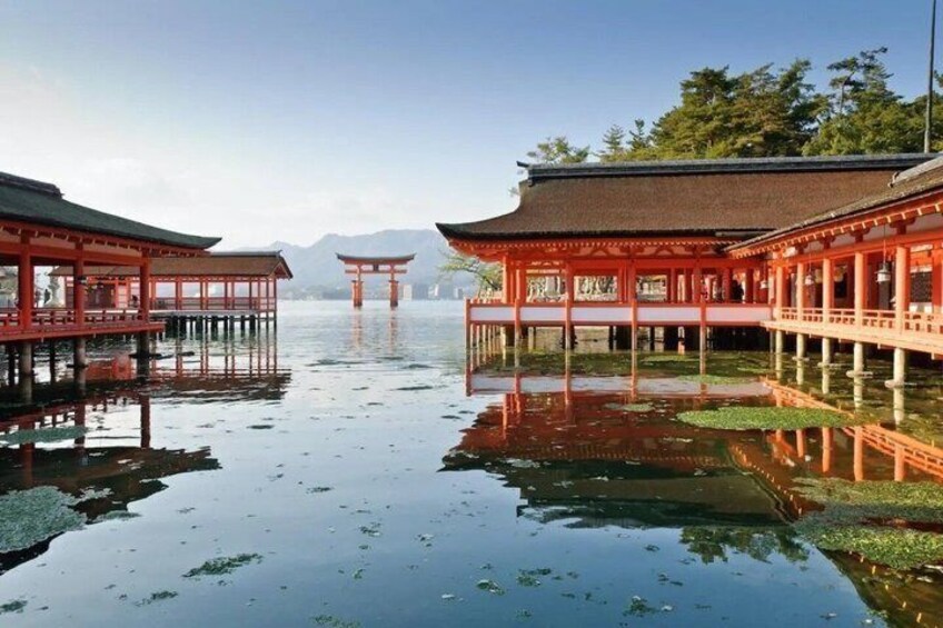 Traditional Japanese architecture with red buildings and a calm water body. 5