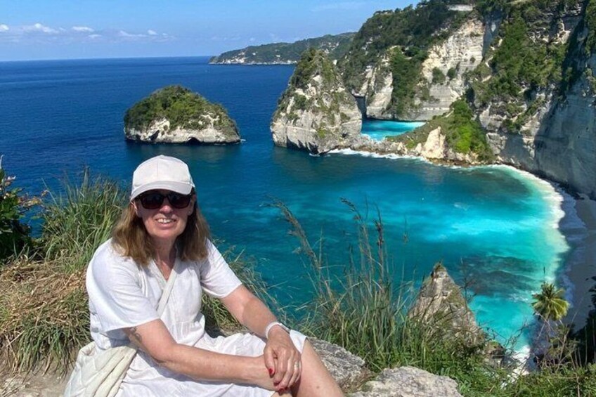 A coastal landscape with cliffs and turquoise waters. 4