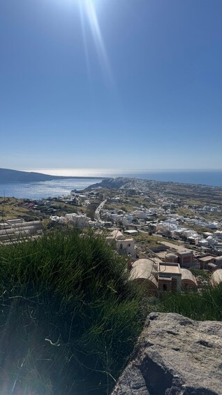 A coastal town with buildings, a clear sky, and the sea. 2