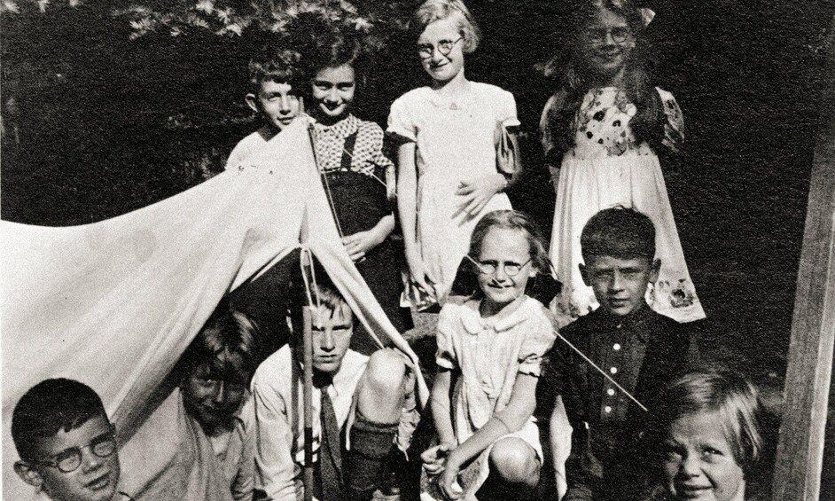 A group of people in a tent-like structure outdoors. 5