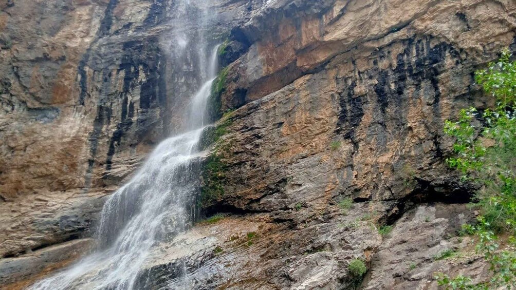 A waterfall cascading down a rocky cliff. 5