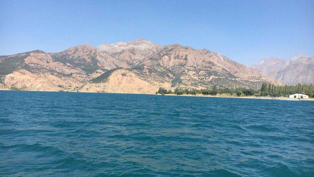 A calm sea with a mountainous landscape in the background. 2