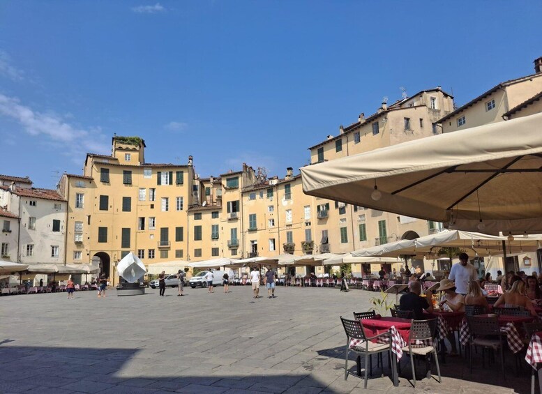 A square with outdoor seating, surrounded by historic buildings. 3