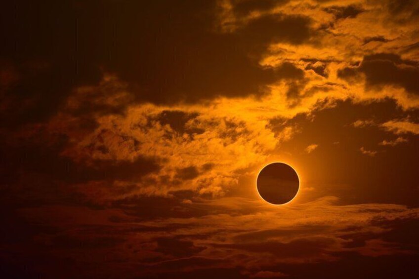 A solar eclipse with a ringed sun and clouds. 1